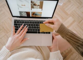 AliExpress Fined Under Digital Services Act Person shopping online using a laptop and credit card, highlighting e-commerce convenience.
